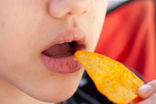 girl eating corn chips girl eating corn chips
macro shooting prison meal stock pictures, royalty-free photos & images