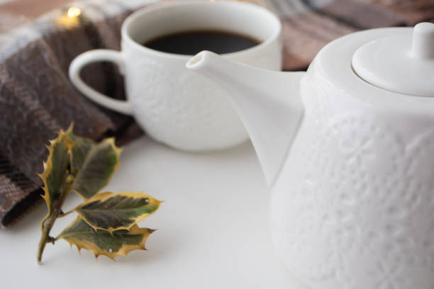 A cup of coffee, chocolate and a pot with warm scarf