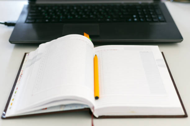 istock Top view of a laptop, next to which lies a notebook 1218176380