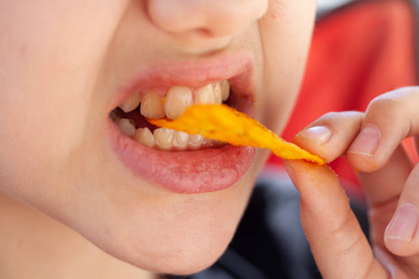 girl eating corn chips girl eating corn chips
macro shooting prison meal stock pictures, royalty-free photos & images