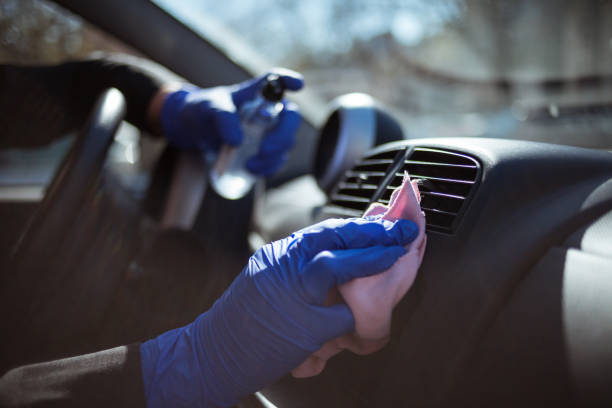 istock Woman wiping down steering wheel 1218177221