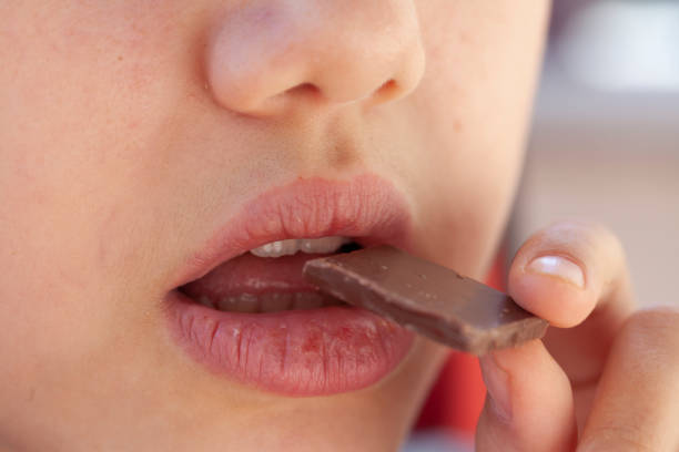 istock girl eating chocolate 1218177314