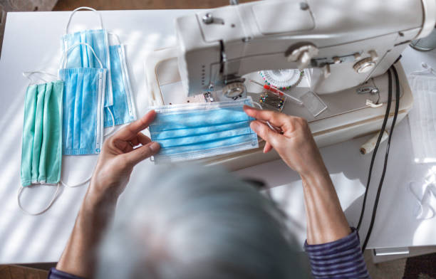 istock Woman working at the sewing machine at home 1218177714