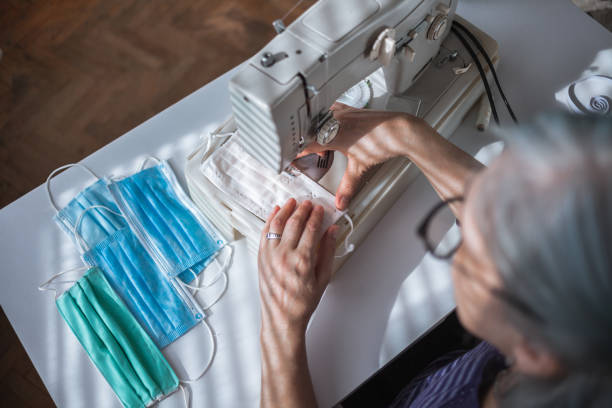 istock Woman working at the sewing machine at home 1218177737
