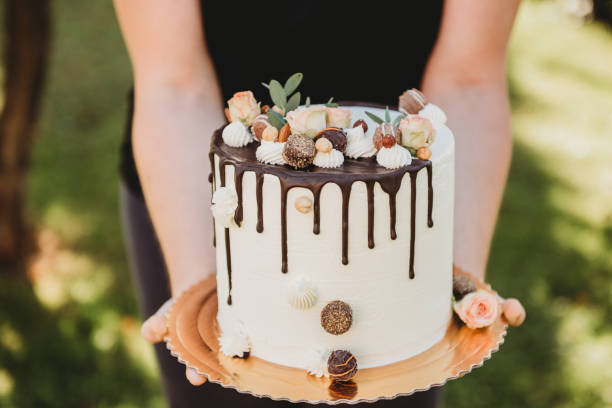 istock young woman holding birthday wedding cake 1218178569