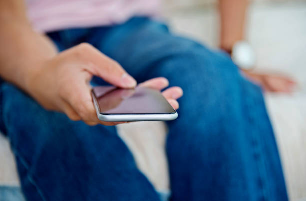 istock Man hand holding a smartphone at home 1218179199