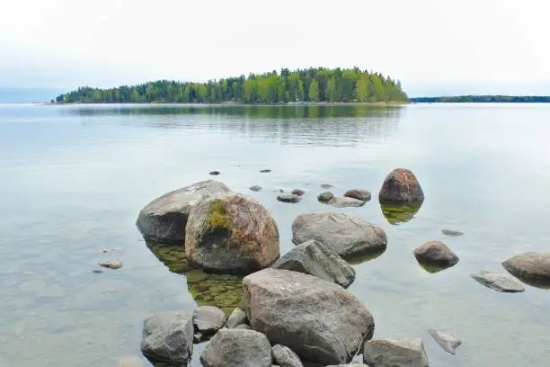 Stones on shore, isle in horizon, Finland