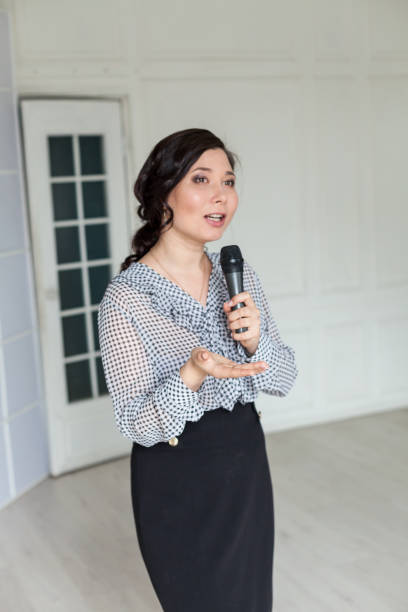 istock Asian woman in business suit talks in office with client 1218179873