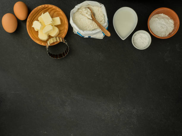 istock eggs, butter, milk, sugar, baking powder, cutter and flour on slate background 1218181795