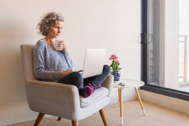 istock Middle aged woman working from home 1218182168