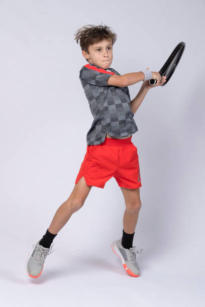 istock Boy playing tennis on white background 1218183622
