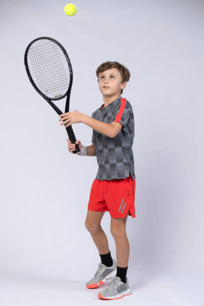 istock Boy playing tennis on white background 1218183651