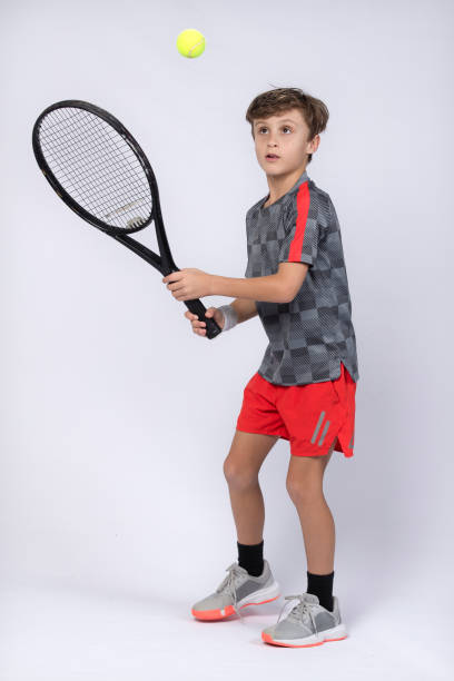istock Boy playing tennis on white background 1218184193