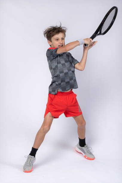istock Boy playing tennis on white background 1218184194