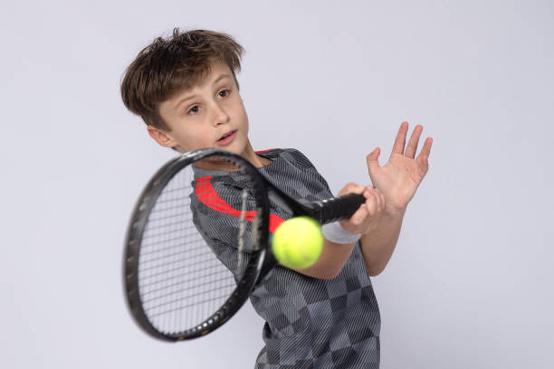 istock Boy playing tennis on white background 1218184201
