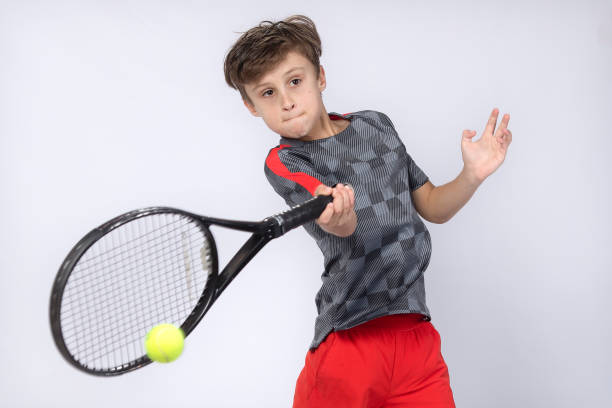 istock Boy playing tennis on white background 1218184365