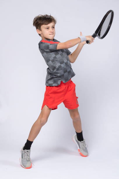 istock Boy playing tennis on white background 1218184566