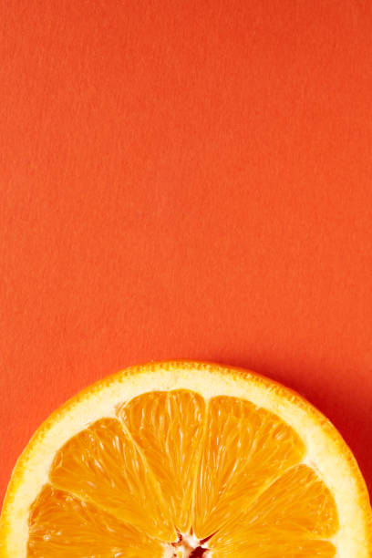 istock Slice of orange on orange background with copy space 1218186168