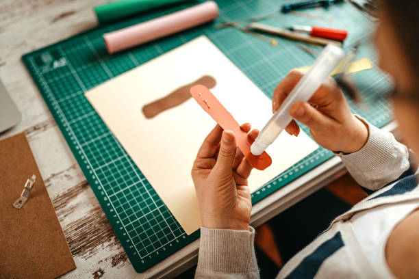 Design professional applying glue on color sample