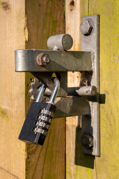 istock Combination Padlock securing the latch on a wooden gate 1218187375