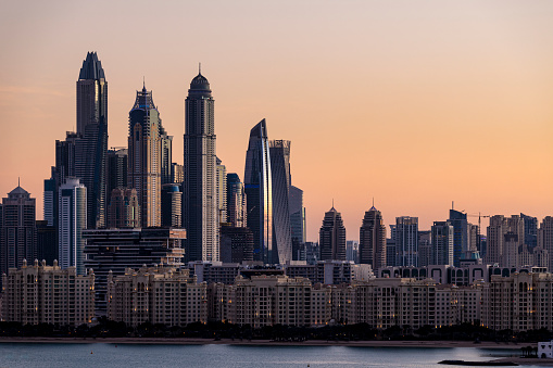 Dubai Marina skyline at sunset. View from the outer part of the Palm Jumeirah.