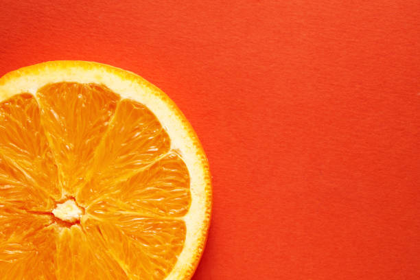 istock Slice of orange on orange background with copy space 1218187466