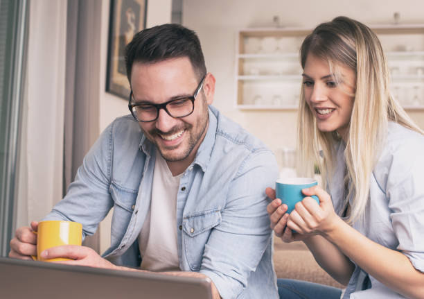 istock Young couple looking at tablet at home 1218187806