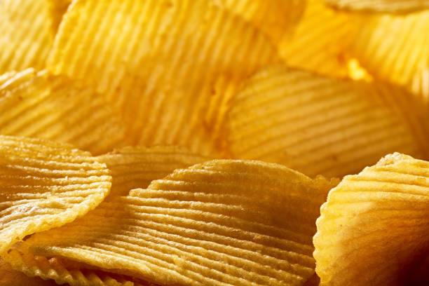 istock Heap of corrugated potato chips background 1218189780