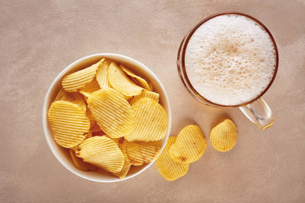 potato chips and glass of beer on rustic wooden background - foods and drinks clothing garment household equipment imagens e fotografias de stock
