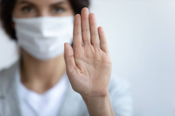 istock Young woman calls stop spreading world outbreak virus infection. 1218193637