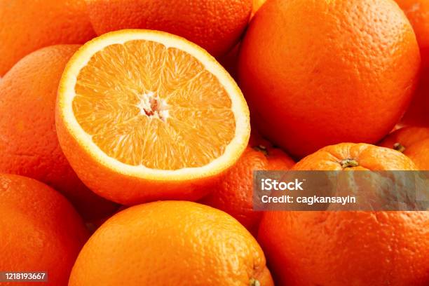 Heap Of Fresh Oranges With One Half Slice Stock Photo - Download Image Now - Orange - Fruit, Orange Color, Textured