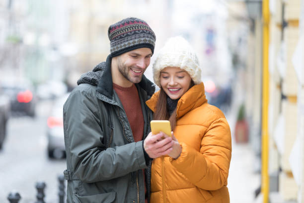 istock Young couple walking the city streets 1218194673