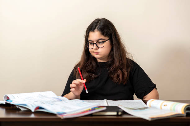 istock 13 years old girl doing homework 1218194848
