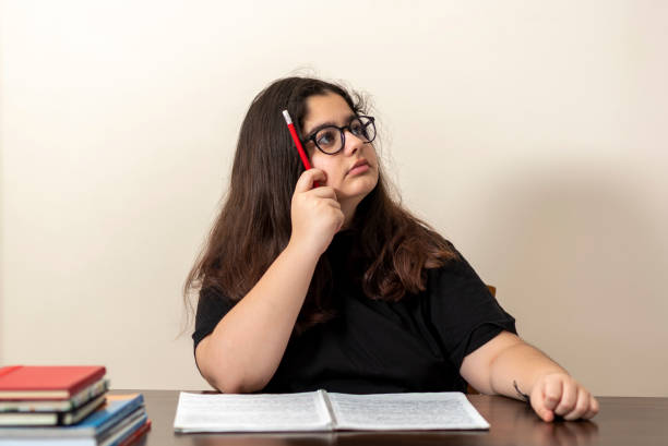 istock 13 years old girl doing homework 1218194897