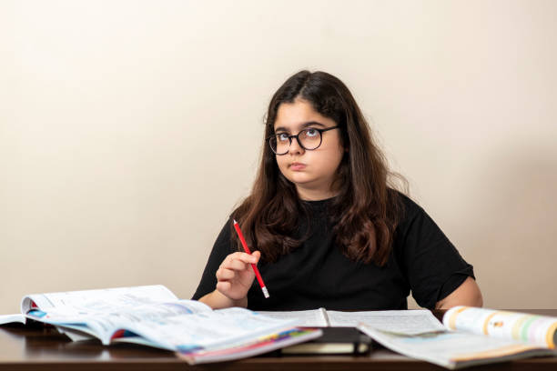 istock 13 years old girl doing homework 1218195585