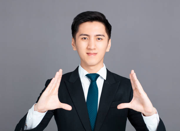 istock young business man with holding and showing gesture 1218195881
