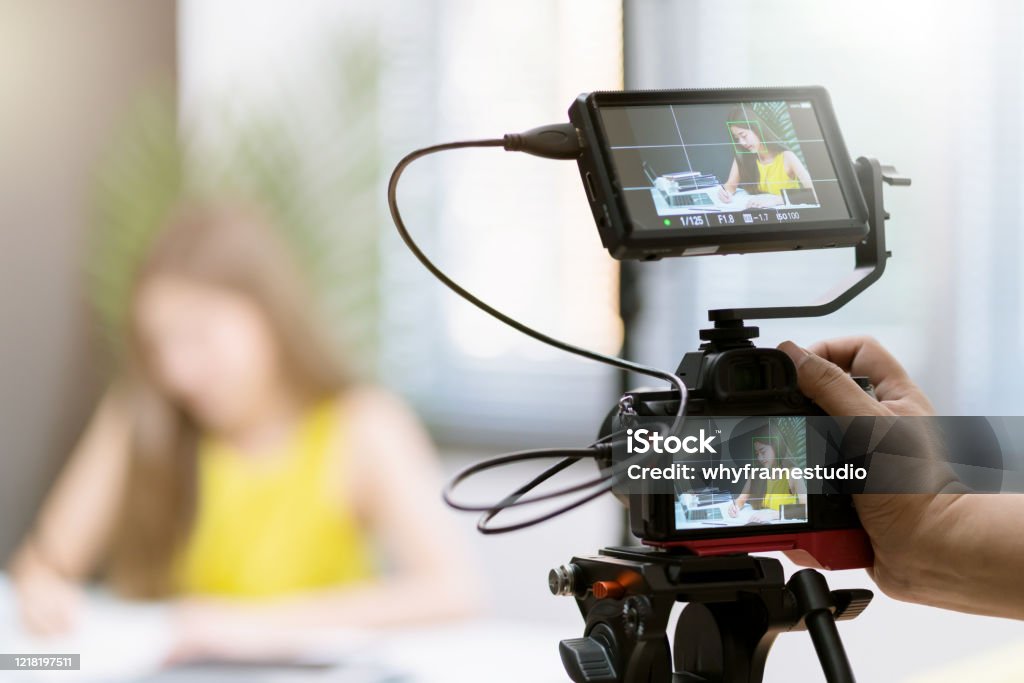 close up camera gear shooting attrative asian female business woman yellow casual dress enjoy working routine with laptop  office background Home Video Camera Stock Photo