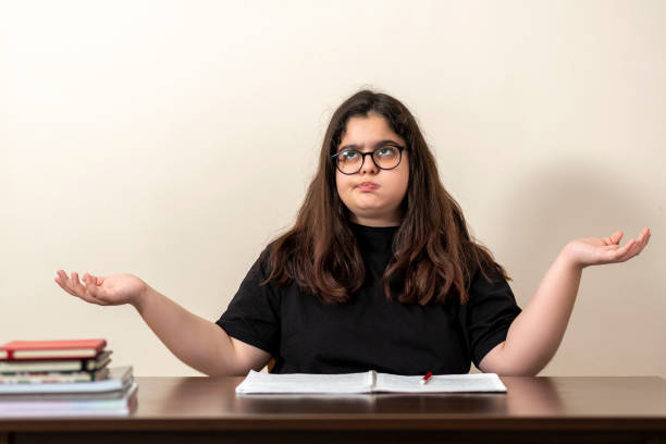 istock 13 years old girl doing homework 1218200017