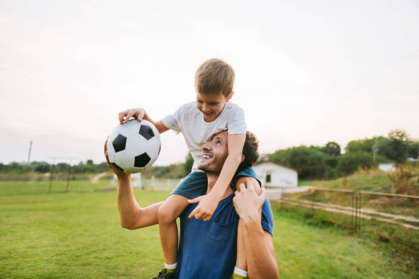 улыбающиеся футболисты - fathers day one parent family day стоковые фото и изображения