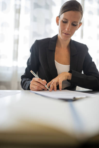 istock Businesswoman signing a document 1218201624