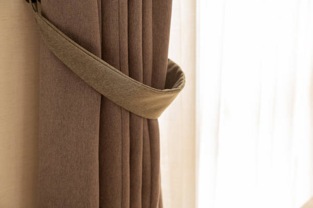 istock soft brown curtain with morning light from window bedroom background 1218201870