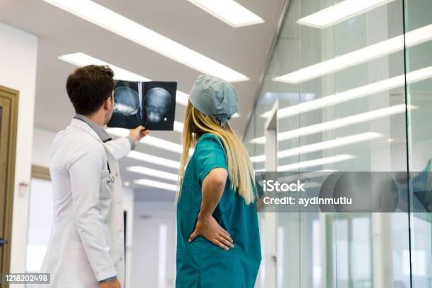 Young Healthcare Professional Looking Xray Of The Patients Skull Stock Photo - Download Image Now