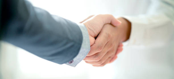 istock business successful contract agreement two businessman handshake with confident and powerful mission achievement white background 1218202583