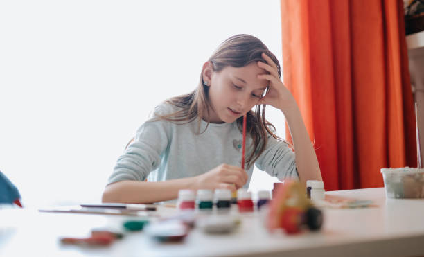 istock Girl decorating clay pottery 1218203292
