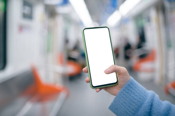 istock Woman's hand is holding and using a smart phone in subway train. 1218204585