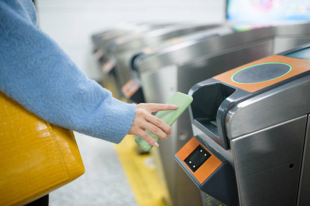 istock Young woman using smart phone to pay at metro station. 1218204619