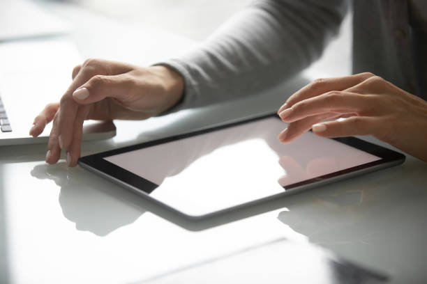 istock Female employee texting on modern tablet gadget 1218204682