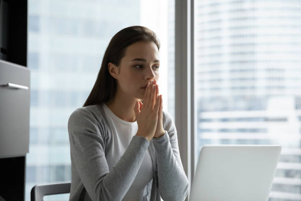 istock Superstitious young woman hold hands in prayer praying 1218204690
