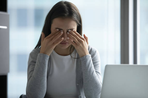 istock Exhausted female employee suffer from headache at workplace 1218204719