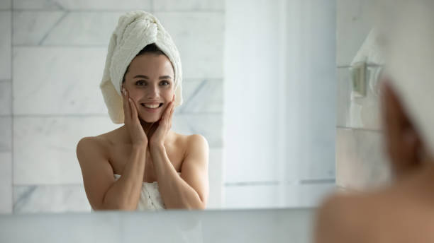 istock Smiling young female touch healthy face skin 1218204757